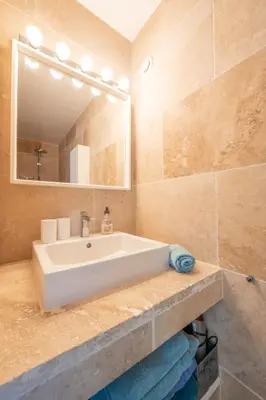a bathroom with a white sink and a mirror at Mas Noves - Horizon Alpilles villa in Noves
