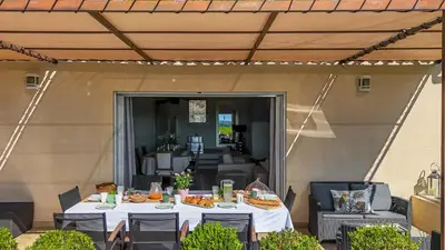 a table with food on it on a patio at Mas Noves - Horizon Alpilles villa in Noves