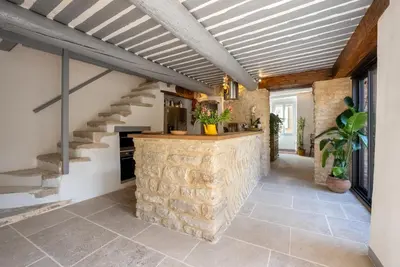 a bedroom with a bed and a view of a bathroom at Beautiful house - Heart of village - Sleeps 10 in Goult