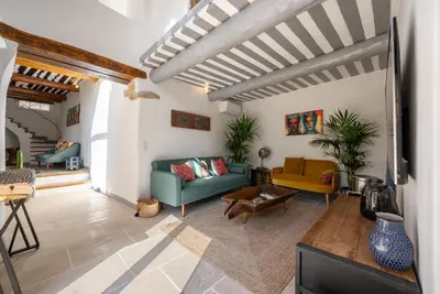 a living room with a couch and a table at Beautiful house - Heart of village - Sleeps 10 in Goult