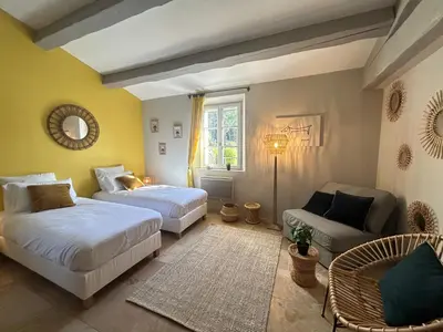 a bedroom with two beds and a couch at Bastide Lavandin - Stunning Provencal Escape in Ventabren