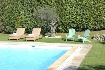 three lounge chairs and a swimming pool in a yard at Bastide Lavandin - Stunning Provencal Escape in Ventabren