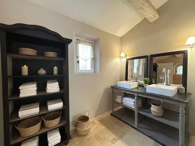 a bedroom with two beds and a desk and a table at Bastide Lavandin - Stunning Provencal Escape in Ventabren