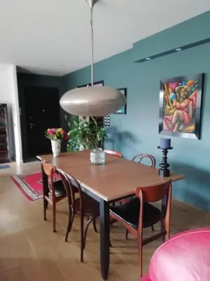 a dining room table with chairs and a pendant light at Maison individuelle in Morières-lès-Avignon