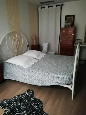 a bedroom with a bed with a dresser and a dresser at Maison individuelle in Morières-lès-Avignon