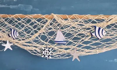 a rope basket with a sailboat on it at Studio Bleu Aix-en-Provence terrasse, piscine, parking in Aix-en-Provence