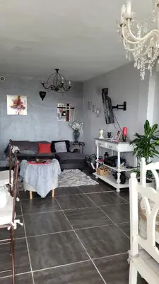 a living room with a table and chairs and a chandelier at Maison de charme in Pierrevert