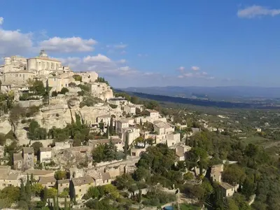 a village on top of a hill with houses at Bastidon du Chene in Gordes