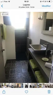 a kitchen with wooden cabinets and a sink at Les Esperelles in Lagnes