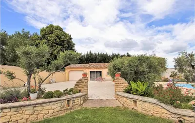 a house with a stone wall and a driveway at Beautiful Home In Lancon De Provence in Lançon-Provence