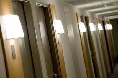 a row of mirrors in a bathroom with lights at B&B HOTEL Salon de Provence in Salon-de-Provence