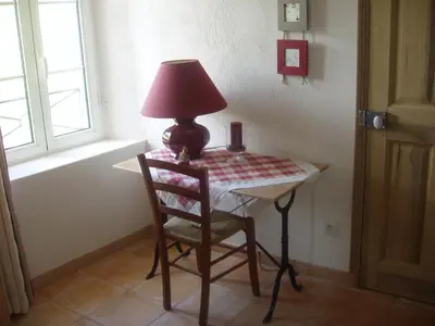 a lamp sitting on a table with a chair at B&B Les Argiles in Mérindol
