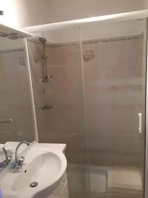 a bathroom with a sink and a glass shower at Auberge Les Olivades in Mallemort