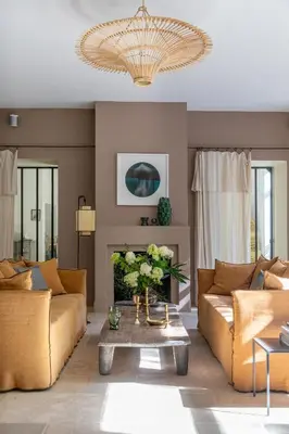 a living room with two couches and a chandelier at La Magnanerie de l'Isle B&B in LʼIsle-sur-la-Sorgue
