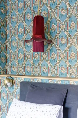 a red lamp hanging above a bed in a bedroom at La Magnanerie de l'Isle B&B in LʼIsle-sur-la-Sorgue