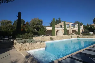 a large swimming pool in front of a house at Le Mazet du Domaine in Gordes