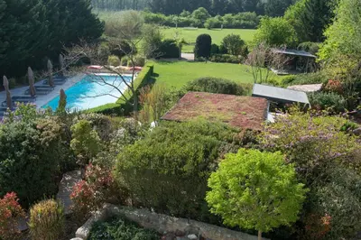 an aerial view of a garden with a swimming pool at Les Carmes and spa in Le Thor