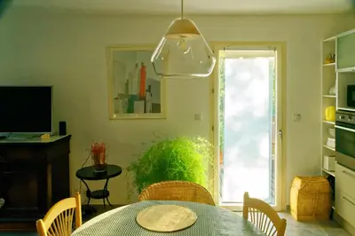 a dining room with a table and a window at La Rousse in Roussillon