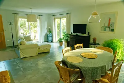 a living room with a table and a couch at La Rousse in Roussillon