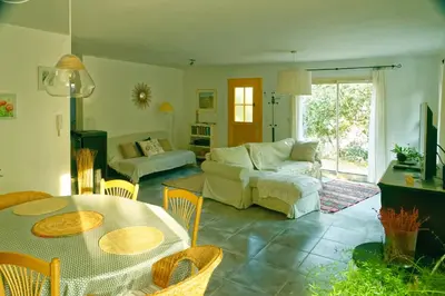a living room with a table and a couch at La Rousse in Roussillon