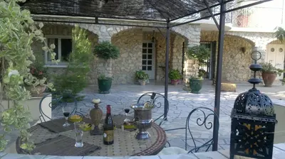 a patio with a table and chairs in a building at Gîtes maisons de vacances Domaine la Chamade Carpentras in Carpentras