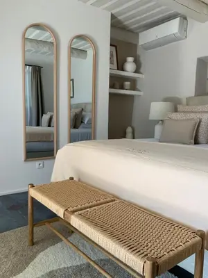 a bedroom with a large white bed and mirrors at Le Mas Les Eydins in Bonnieux