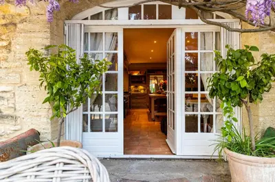 an entrance to a store with white doors at Le Clos de Lucie in Lagnes