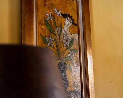 a picture of a painting of a woman with flowers at L'Escarpolette in Saint-Saturnin-les-Apt