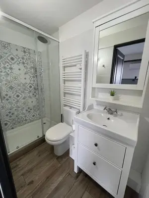 a bedroom with a large bed and a kitchen at Casa Hotel in Aix-en-Provence