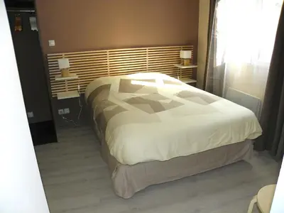 a bedroom with a large bed and a window at Provencal Vintage Cocoon in LʼIsle-sur-la-Sorgue