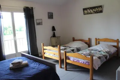 a bedroom with two beds and a window at La Sarriette - Chambres d'hôtes et gîte d'étape à Eygalières in Eygalières