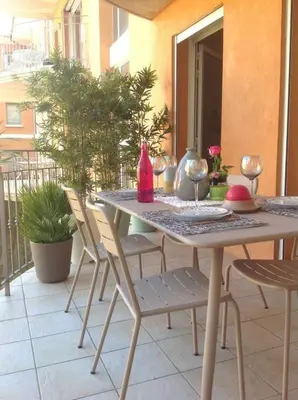 a table and chairs sitting on a patio at Les Jardins de Mistral Apartment in Aix-en-Provence