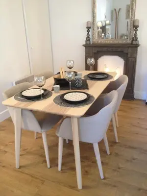 a dining room table with chairs and a table with glasses at Les Jardins de Mistral Apartment in Aix-en-Provence