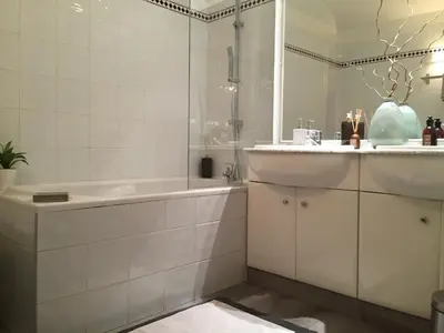 a bathroom with a tub and a sink and a shower at Les Jardins de Mistral Apartment in Aix-en-Provence