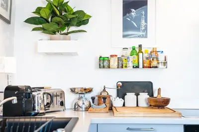 a kitchen with a counter with a toaster and a sink at Lumineux Aix Plein Centre avec Parking privé Gratuit in Aix-en-Provence