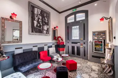 a living room with a couch and a table at Hôtel de Charme Le Provence in Salon-de-Provence