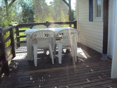 a white table and chairs sitting on a porch at B&B La Douloire in Pernes-les-Fontaines
