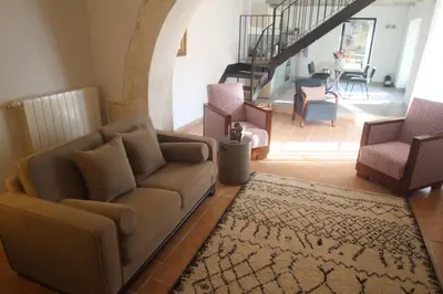 a living room with a couch and two chairs at Les Guillaume Rey in Oppède