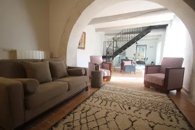 a living room with a couch and two chairs at Les Guillaume Rey in Oppède