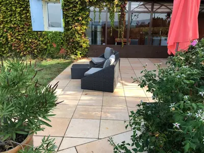 a patio with two couches sitting on a patio at Luberon & Lavandes in Roussillon