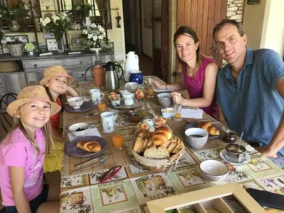 a group of people sitting around a table with food at Le Verger in Gordes