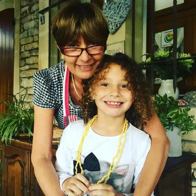 a woman is hugging a little girl at Le Verger in Gordes