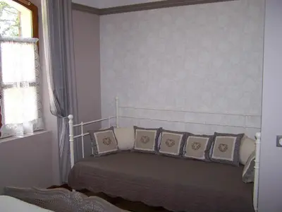 a bedroom with a bed with pillows and a window at Le Verger in Gordes