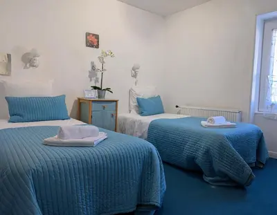 a bedroom with two beds with towels on them at L'Aiguebelle in Céreste