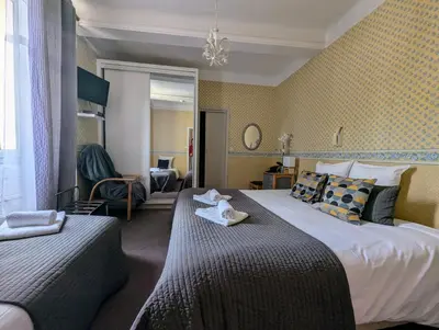 a hotel room with two beds with towels on them at L'Aiguebelle in Céreste