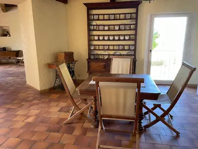a dining room with a wooden table and chairs at Château de la Gabelle Férrassières in Ferrassières