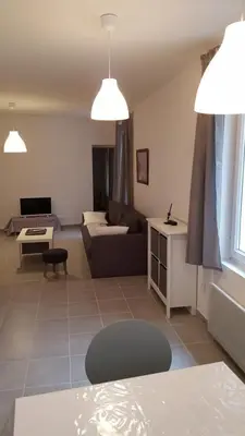 a living room with a couch and a table at Colombe in LʼIsle-sur-la-Sorgue