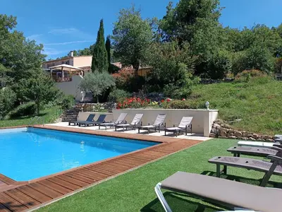 a swimming pool with lounge chairs next to a house at Mas Auroma in Murs