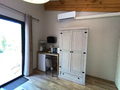 a room with a cabinet and a desk with a computer at Mas Auroma in Murs