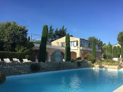a house with a swimming pool in front of a building at Bastidon la Cicada in Gordes